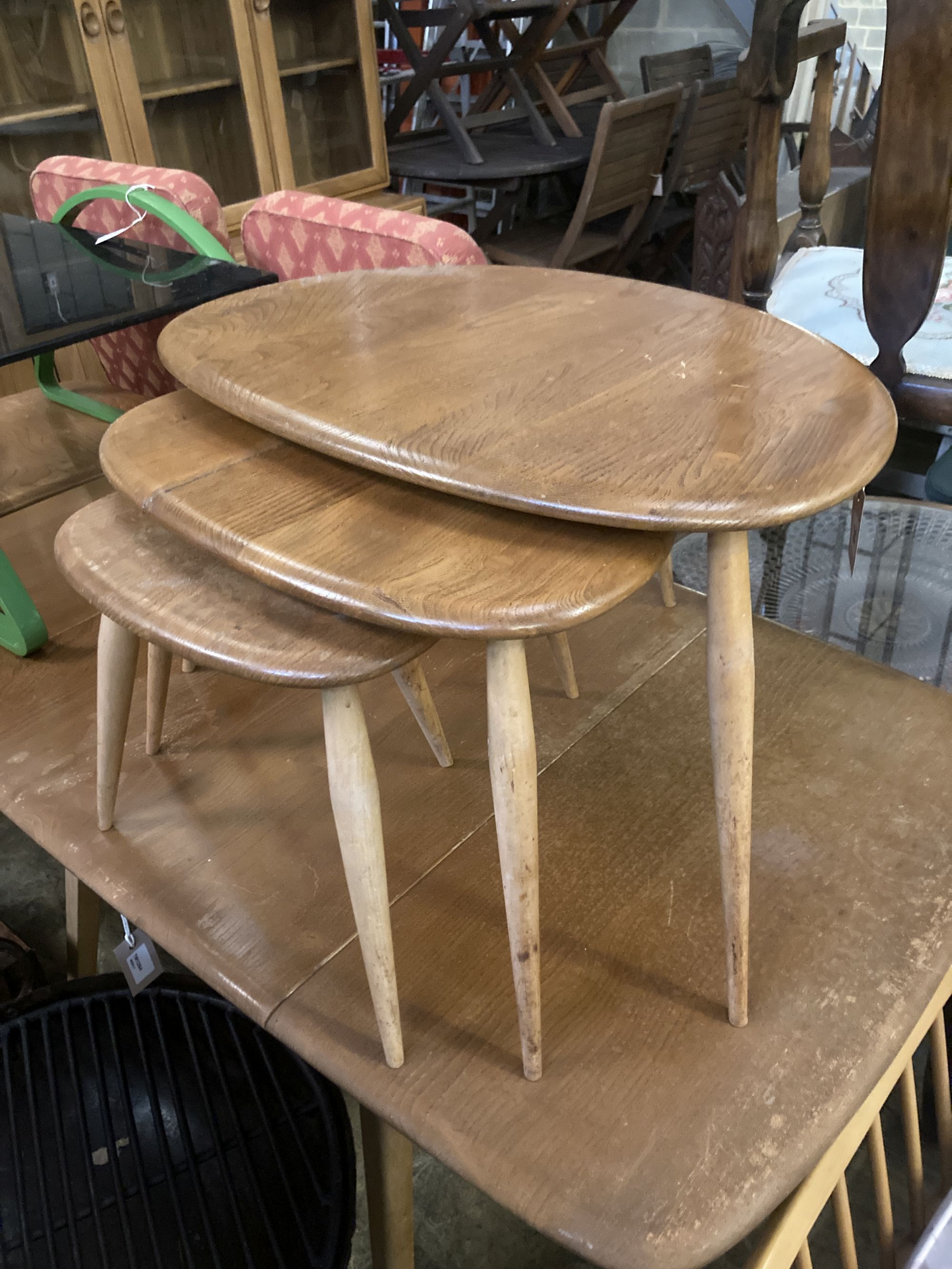 An Ercol nest of three Pebble tables, width 64cm depth 42cm height 40cm